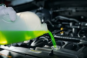 PouringAntifreezeCoolantLiquidIntoCarEngineRadiator - Meineke New Hampshire Meineke Car Care | Radiator Flush | Concord NH